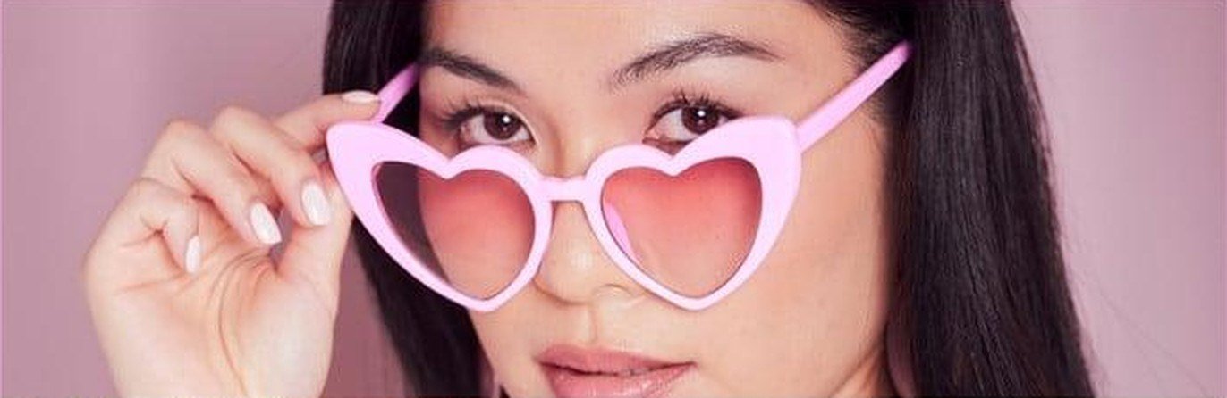 Irena Kim wearing pink heart sunglasses
