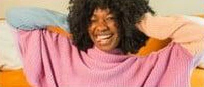 Smiling designer in a pink sweater